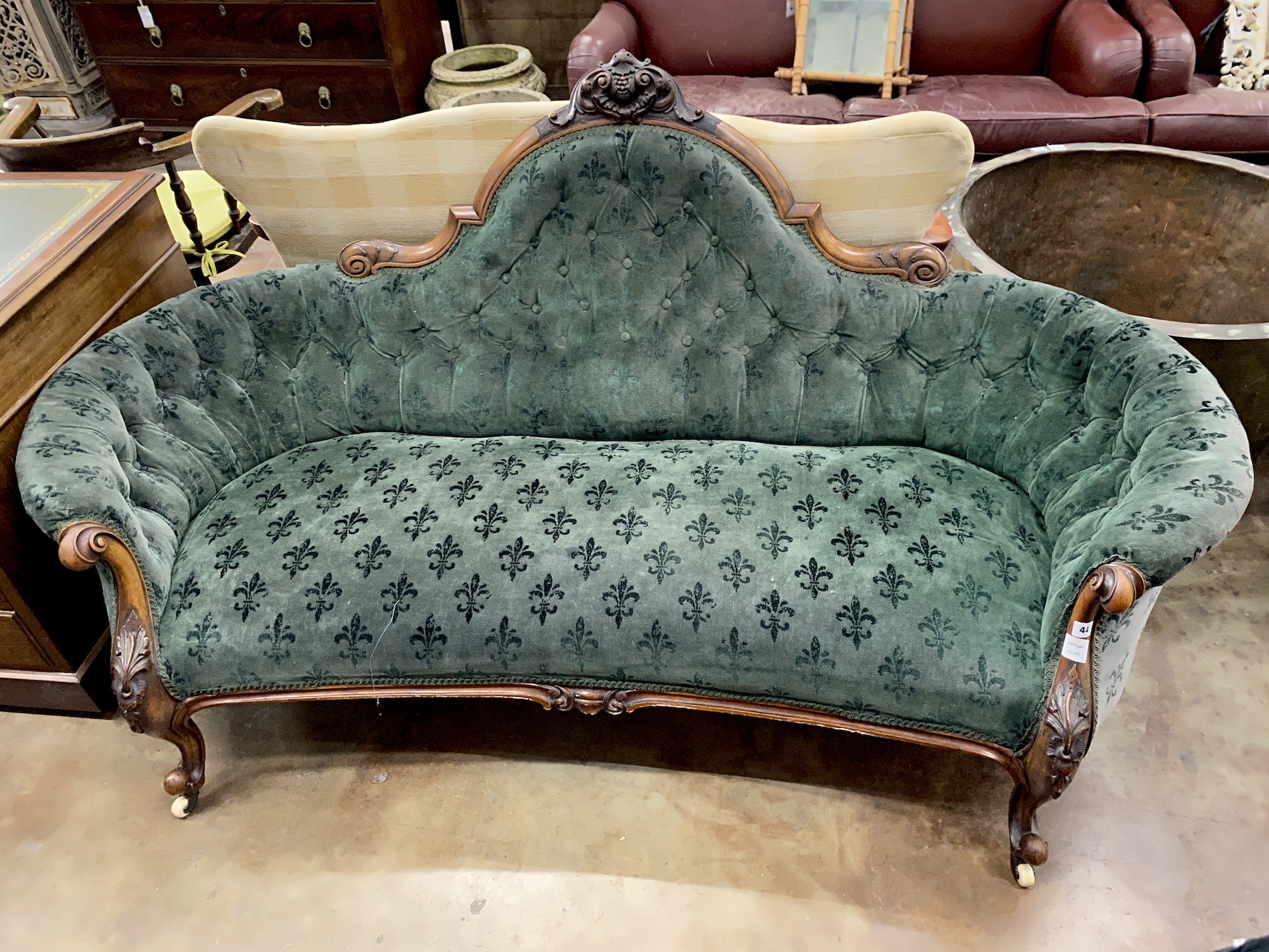 A Victorian walnut settee upholstered in green fleur de lys buttoned fabric, length 190cm, depth 94cm, height 95cm